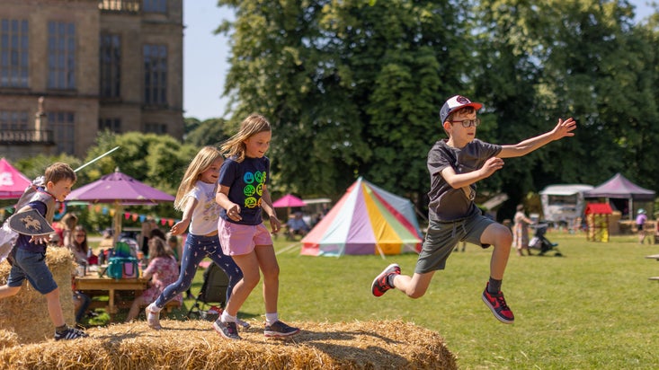 Kids jumping around the haybales at Hardwick's Summer of Play